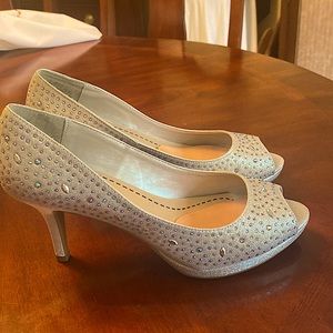 Glittery open toe 2” pump shoe.